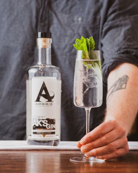 ak's gin served in a cocktail by a bartender behind the bar