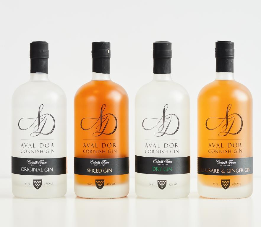 the full range of colwith farm distillery gind lines up in a row