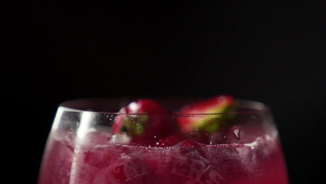 details of a drink with fresh berries to garnish